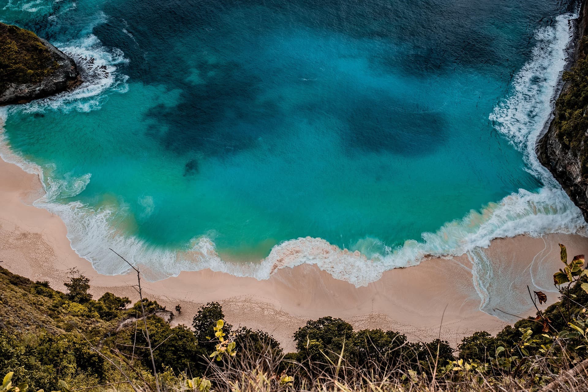 A stunning aerial view of a Sri Lankan beach with palm trees and turquoise water.